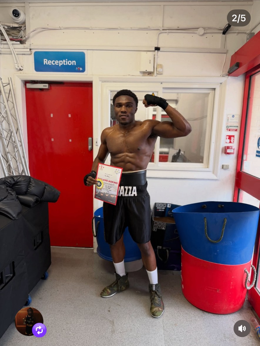 Taha Barry holding his England Boxing championship certificate